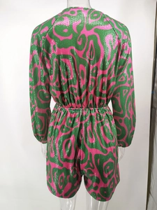 Detailed back view of pink and green sequined long sleeve romper with striped pattern