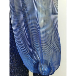 Detail of dark blue sequins and metallic pleated mesh fabric on evening dress