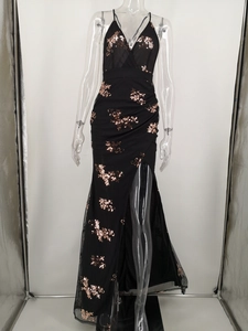 Detail of black sequin gown featuring a deep V-neck, rose gold floral patterns, and high slit