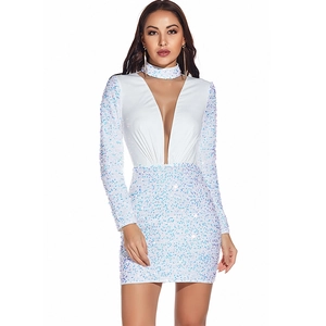 Detailed close-up of white sequin texture on deep V-neck long sleeve party dress