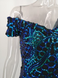 Detailed view of honeycomb sequin texture on an off-the-shoulder evening gown