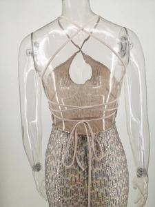 Detailed view of backless sequined evening gown with criss-cross straps and wave patterns