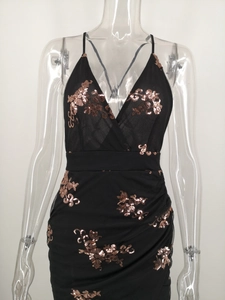 Close-up of black mesh dress featuring bronze sequin floral embroidery and V-neckline
