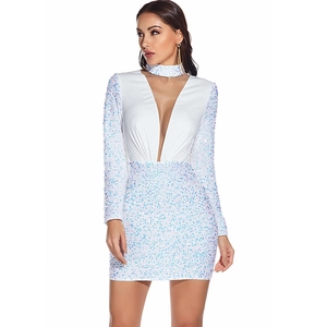 Detailed view of the sparkling white sequins and deep V-neck on this party dress