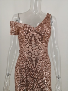 Detail of rose gold sequin evening dress featuring asymmetrical off-shoulder and pleated strap