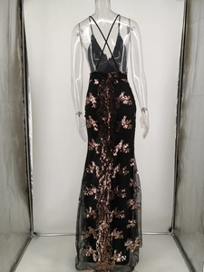 Detailed back view of a black sequin evening gown with rose gold vine patterns and cross straps