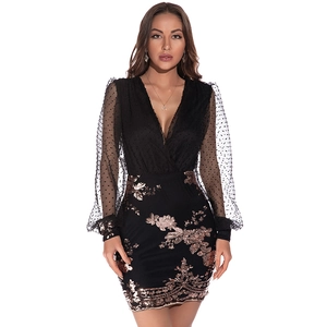 Close-up of sheer mesh sleeves with polka dots and intricate gold sequin embroidery
