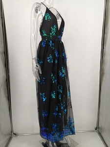 Detail of sequin embroidery and sheer mesh layers on a deep V-neck evening gown