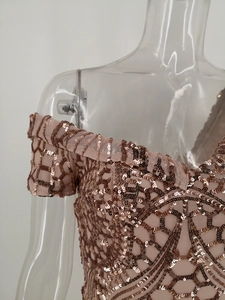 Detail of rose gold sequin embroidery on mesh off-the-shoulder evening gown
