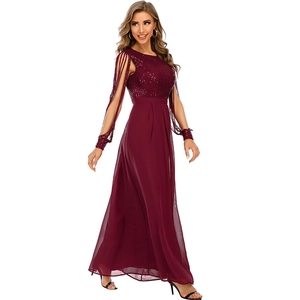 Detail of burgundy sequined evening gown with elegant fringe cape sleeves and chiffon skirt