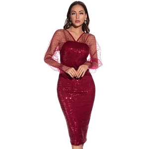 Detail of burgundy sequin dress featuring V-neck and black polka dot mesh sleeves