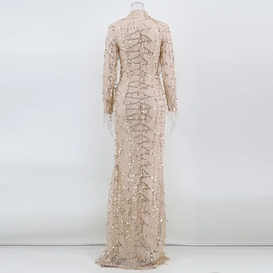 Close-up of gold sequins and geometric mesh texture on high-neck elegant evening gown
