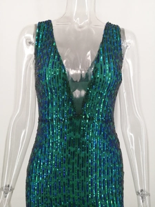 Macro shot of dark green sequins on the sexy backless dress with a V-neck design