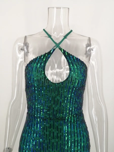 Detail of green sequin halter dress with keyhole cutout and cross neck design