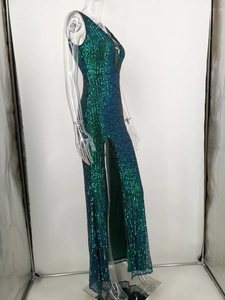 Detail of emerald green sequin evening gown showing high slit and slim fit texture