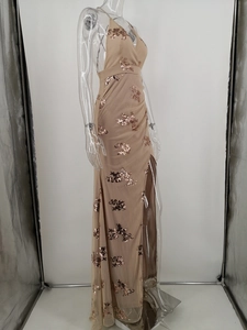 Detail of apricot sequin floral embroidery on a sleeveless mesh halter evening gown