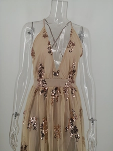 Detailed embroidery of rose gold sequins on a sheer mesh evening dress fabric