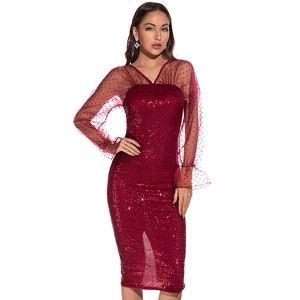 Detail of red sequined dress showing sheer polka dot mesh sleeves and V-neckline