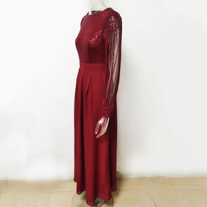 Detail view of burgundy sequined bodice and sheer chiffon sleeves on long evening dress