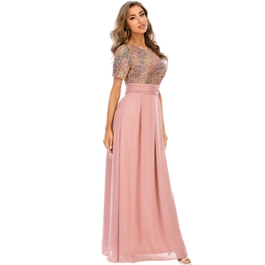 Detail view of colorful sequin bodice and flowing pink chiffon maxi dress on model