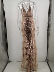 Detail of cross-back straps and bronze sequin embroidery on champagne evening gown