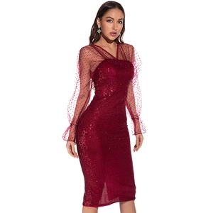 Close-up of burgundy sequined dress with sheer mesh polka dot sleeves and V-neckline