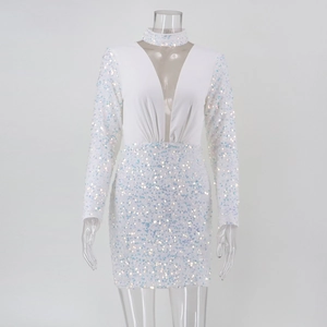 Close-up of a white sequined mini dress with deep V-neckline and sheer mesh insert detail