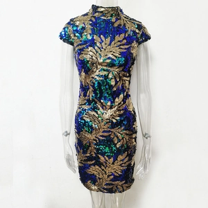 Detail of vintage green and gold sequin leaf pattern on a slim-fit evening mini dress