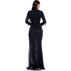Detail of a slim fit black sequin dress with mesh patchwork and long sleeves back view
