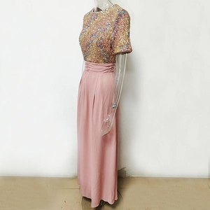 Detailed view of pink chiffon maxi dress with colorful sequined bodice and pleated waist
