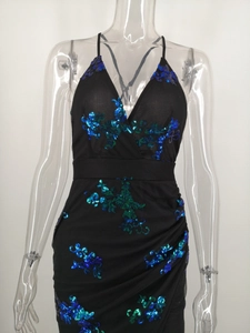 Close-up of sparkling blue sequins and draped pleated detail on sexy V-neck party dress