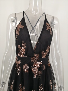 Detail of black sequined evening dress with rose gold embroidery on mesh fabric