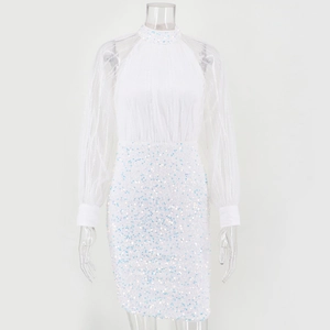 Close-up of mesh sleeves and shimmering white sequins on a mini cocktail party dress