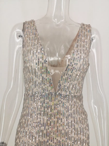 Detail of sequins and mesh patchwork on deep V-neckline of a slim evening dress