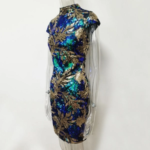 Detail of green and gold sequin mini dress featuring leaf pattern and high collar
