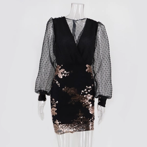 Detail of rose gold sequin floral embroidery on black mesh sleeve of evening dress