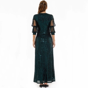 Detailed back view of dark green sequin evening gown with unique cutout puff sleeves