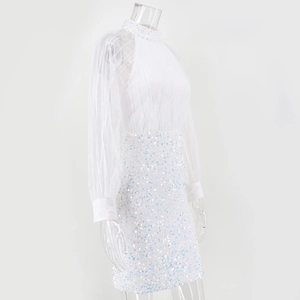 Detailed view of white sequin cocktail dress with sheer mesh sleeves and sequins