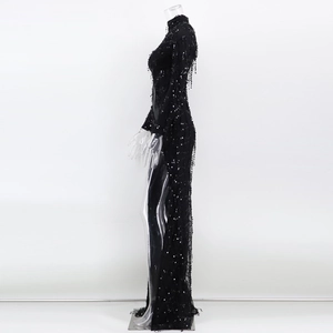 Detailed side view of black sequined gown with fringe tassels and sheer mesh stitching
