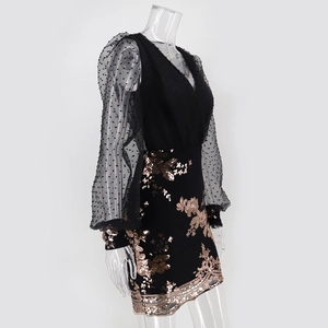Detail of V-neck sequin floral embroidery and mesh puff sleeves on a black dress