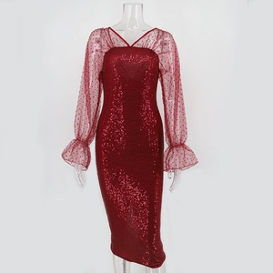 Detail of red sequin dress featuring sheer polka dot mesh sleeves and a V-neckline