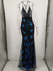 Detail of cross straps and blue floral sequin embroidery on open back fishtail evening dress
