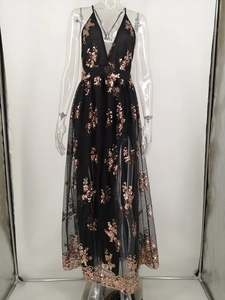 Detail of gold sequin floral embroidery on a black tulle V-neck evening gown dress