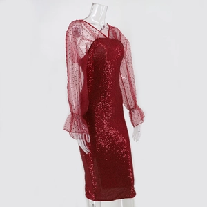 Detailed view of red sequin dress with sheer polka dot mesh sleeves and ruffled cuffs