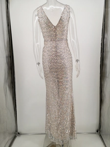 Macro detail of high-density silver sequins and backless V-neck design on evening gown