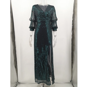 Detail of a dark green sequined evening dress featuring ruffled sleeves and a high slit