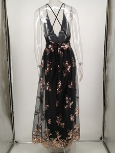 Detail of cross-back straps and rose gold sequin floral patterns on a black mesh dress