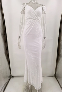 Close-up of elegant white sequin evening dress with V-neckline and draped pleat details