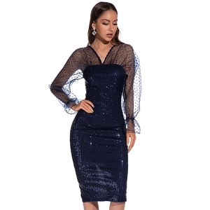 Close-up of navy blue sequins and sheer mesh sleeves on a backless evening dress