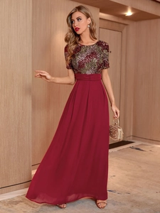 Detail of burgundy sequin bodice and chiffon skirt of a backless evening maxi dress
